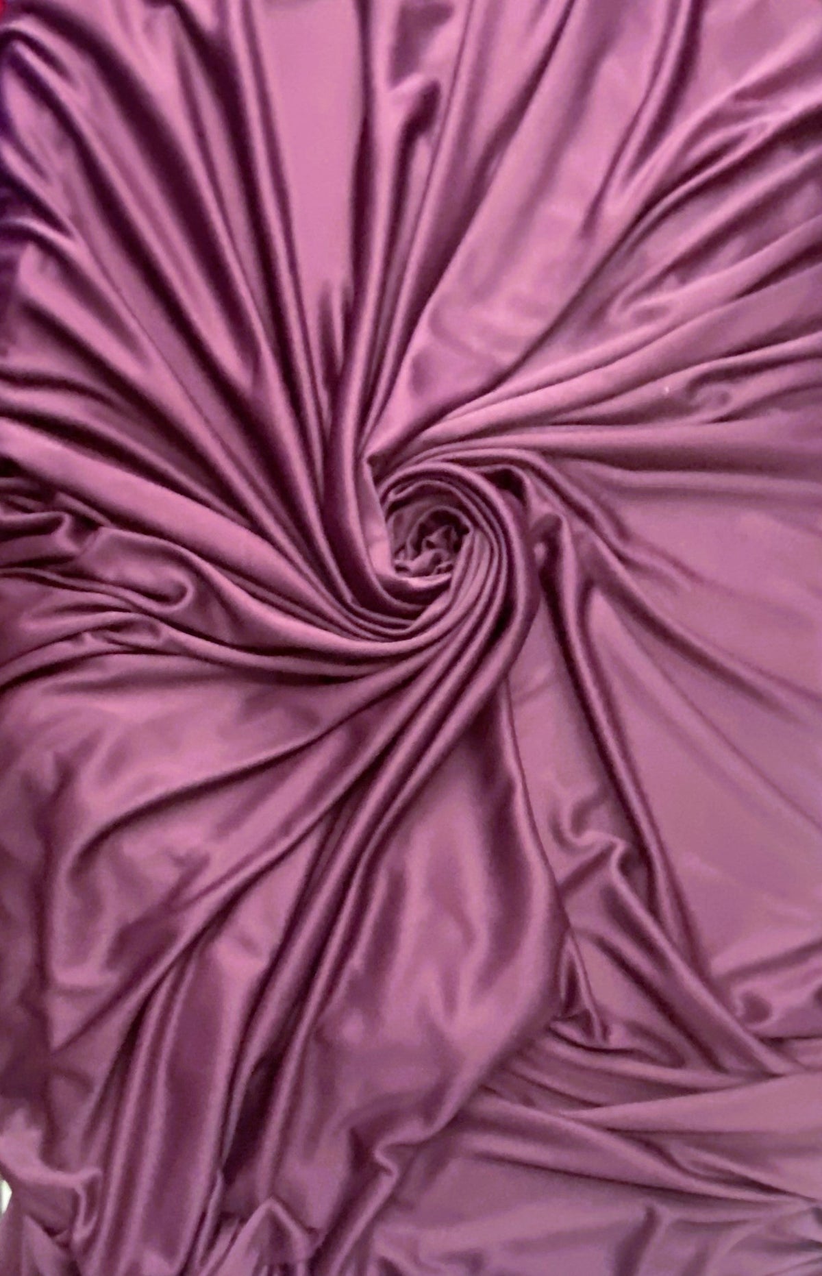 Plum stretch polyester lining fabric with a soft matte surface finish